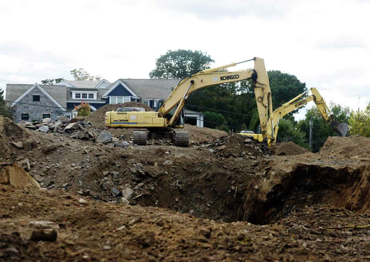 Crews work on a construction site on Milbank Avenue in Greenwich, Conn. Monday, Oct. 18, 2021. Residents at 223-233 Milbank Ave. have been complaining of powerful blasting noises coming from the construction site nearby.