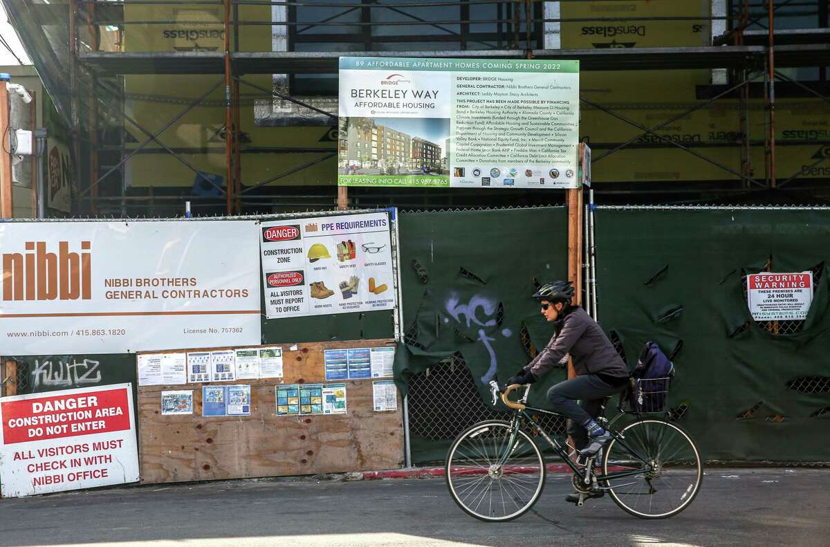 A cyclist passes a new affordable housing project in Berkeley. Plan Bay Area 2050 wants to see more housing projects like this built in the region.