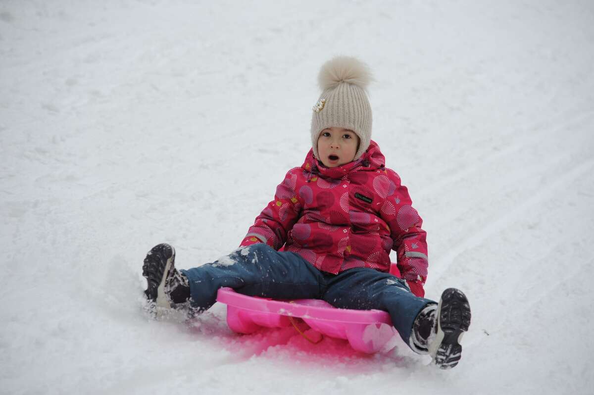 A child sleds at the park during a snowfall. (Photo by Mykola Tys/SOPA Images/LightRocket via Getty Images)