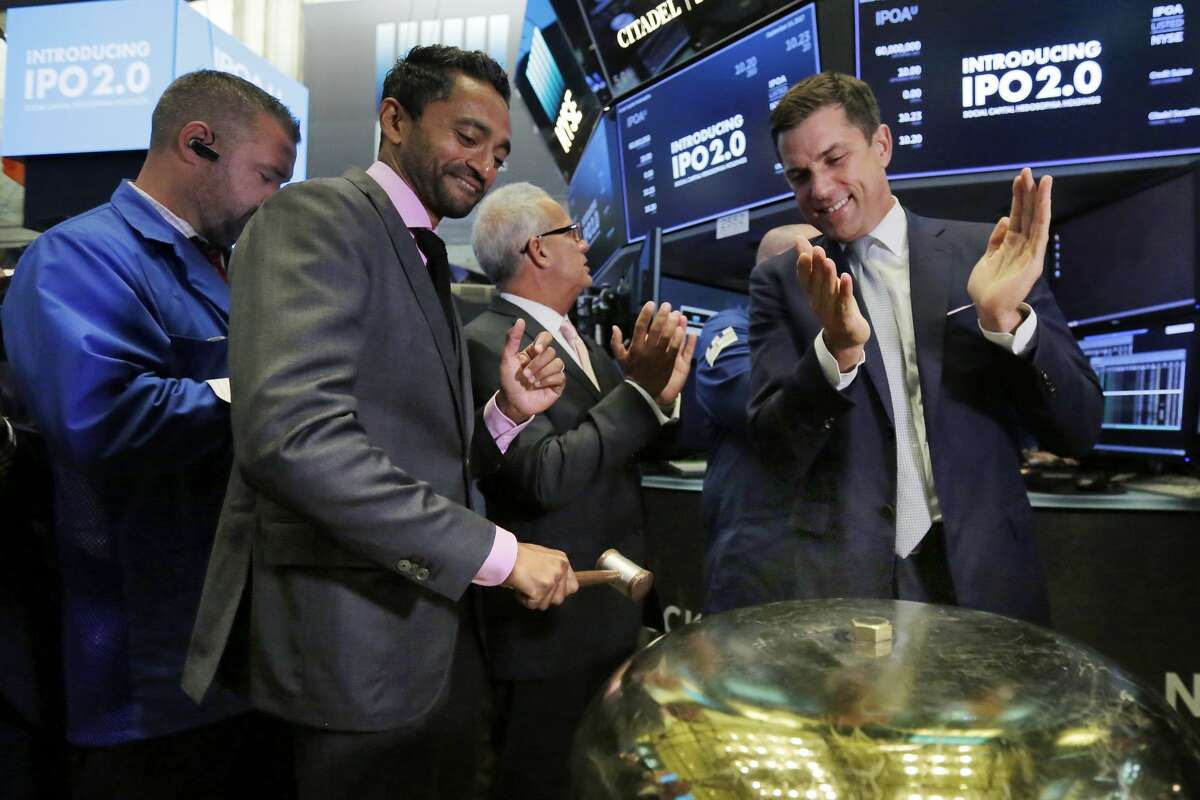 Social Capital CEO Chamath Palihapitiya, left, is applauded by New York Stock Exchange president Tom Farley as he rings a ceremonial bell when his company's stock begins trading on the floor of the New York Stock Exchange, Thursday, Sept. 14, 2017.