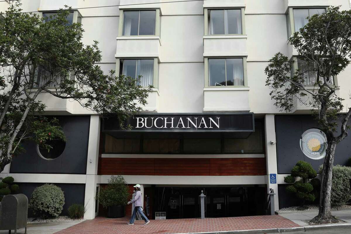 A pedstian walks past the entrance of the Kimpton Buchanan Hotel on Monday, August 26, 2021 in San Francisco, Calif.