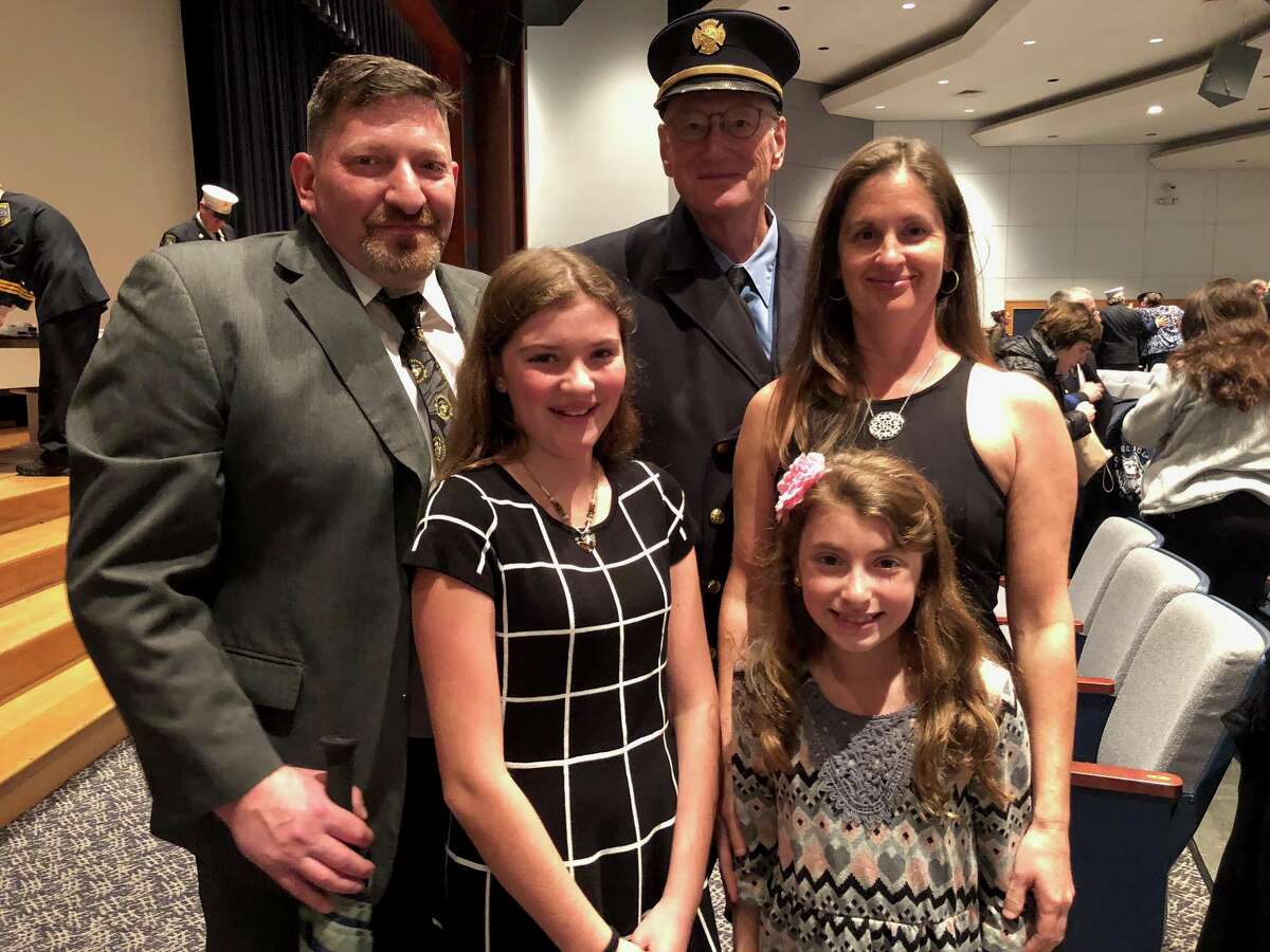 Shelton firefighter David Collins, with his family - Peter and Michelle and granddaughters Dana and Julia - presented the Dolores "Dolly" Collins Award to firefighter Michael Kellett at the fire department awards ceremony Oct. 16.