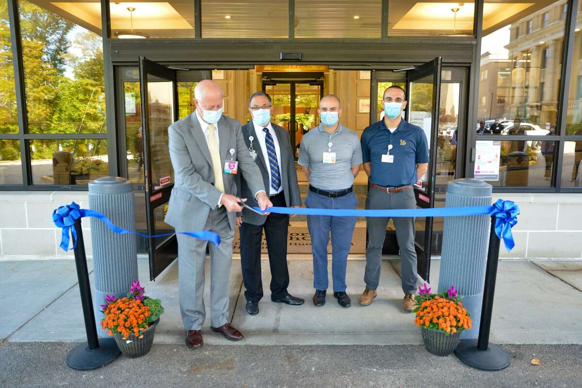 From left are Daniel J. McIntyre, Senior Vice President for Hartford HealthCare and President of Charlotte Hungerford Hospital cuts the ribbon opening the Hospital’s newly renovated main entrance with John Capobianco, HHC Regional Vice President for Operations at CHH, Noah Morgan, HHC Facilities Project Manager, and Demetri Vernadakis of O&GIndustrie.