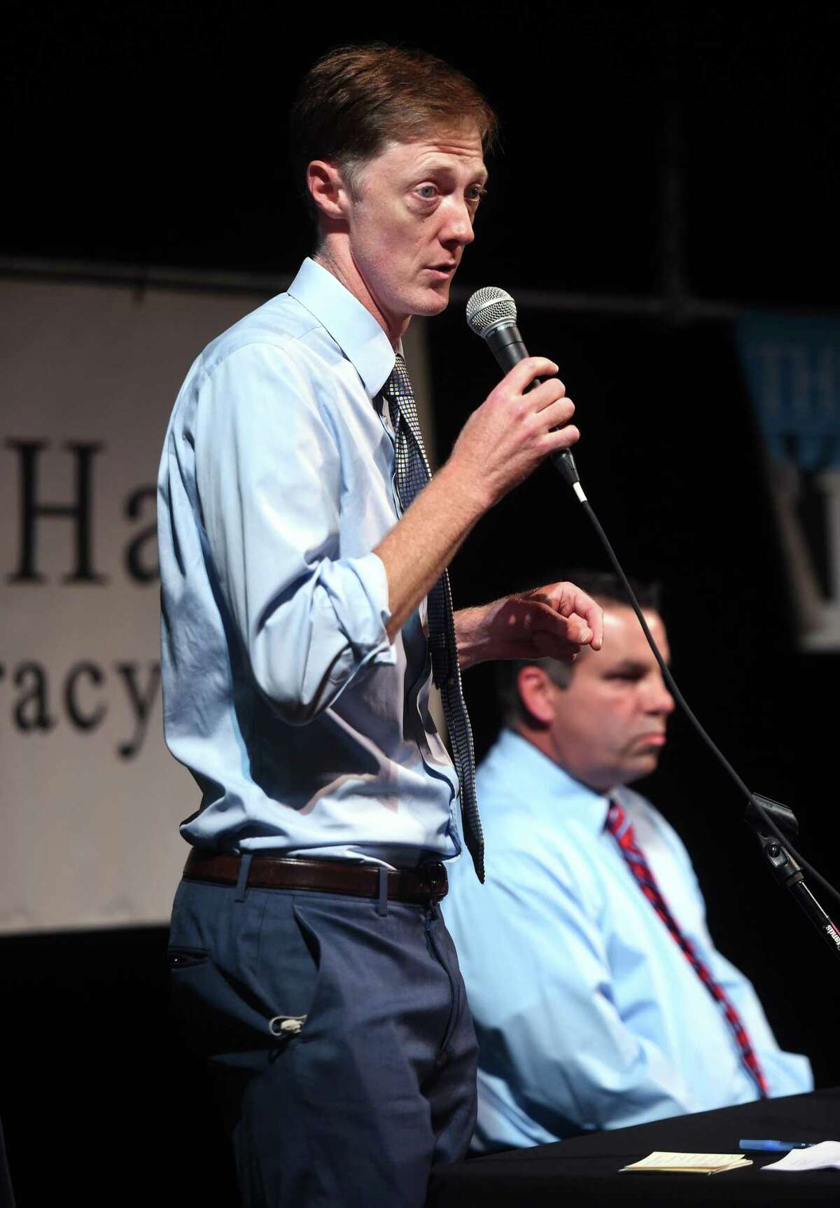 New Haven Mayor Justin Elicker (left) debates challenger John Carlson at Cooperative Arts & Humanities High School in New Haven on Tuesday.