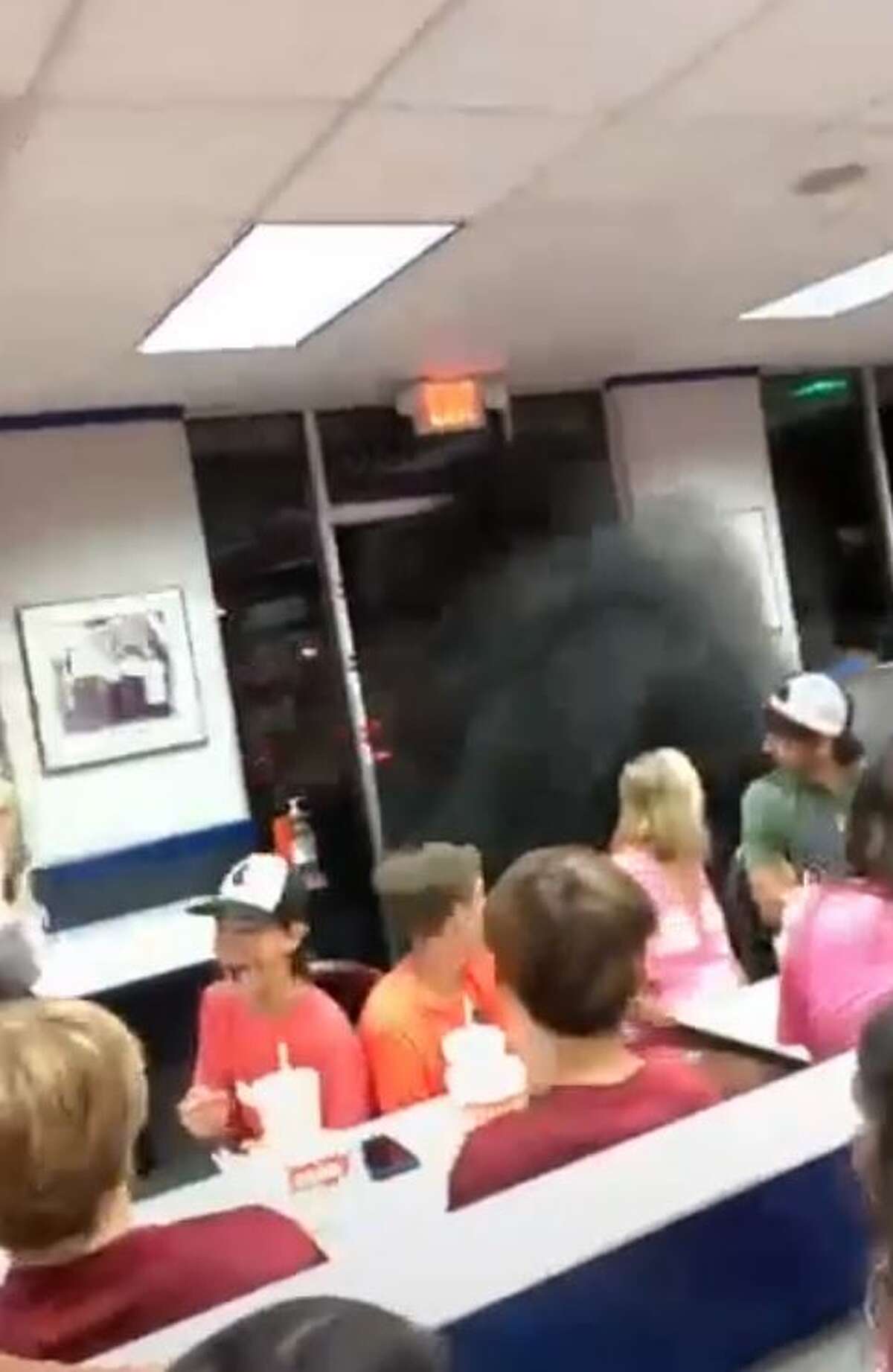 Criticism has poured after an unknown driver of a truck was seen on video "rolling coal" into a Texas Whataburger, filling its packed dining room with black exhaust smoke. 