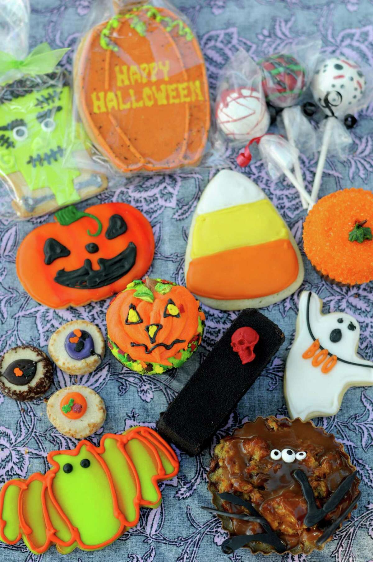 A selection of Halloween-themed treats from San Antonio-area bakeries including (clockwise from top right) Cosmic Cakery, Bird Bakery, Extra Fine and Nadler’s Bakery & Deli