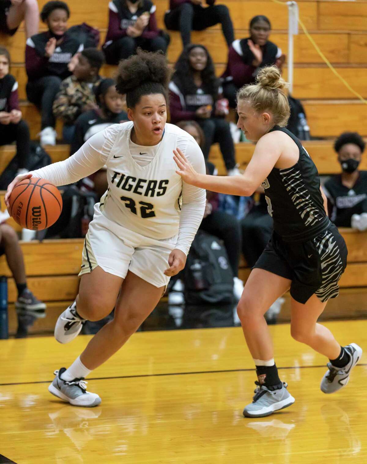 Conroe junior Isabella Stafford (32) looks for an opening to drive the ball passed A&M Consolidated Claire Sisco (4) during the first quarter of a non-district high school basketball game at Conroe High School, Tuesday, Nov. 17, 2020, in Conroe.
