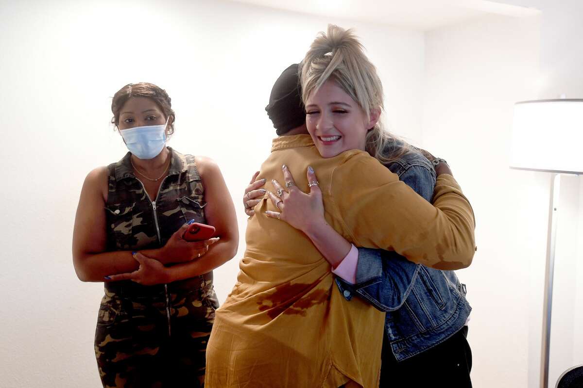 Charrmayne Hadnot hugs make-up stylist Madison Sipes during "Brave and Beautiful" - a make-over day for breast cancer patients and survivors at the Holiday Inn on Walden Road. Photo made Thursday, September 23, 2021 Kim Brent/The Enterprise