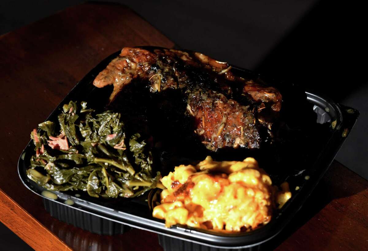 A plate of baked turkey wings, greens and mac and cheese is served at Kitchen 216 on Wednesday, Oct. 20, 2021, on Central Avenue in Albany, N.Y. Restaurant owners Wasiim and Emrys Young are moving the neighborhood favorite into a new space in Crossgates Commons.
