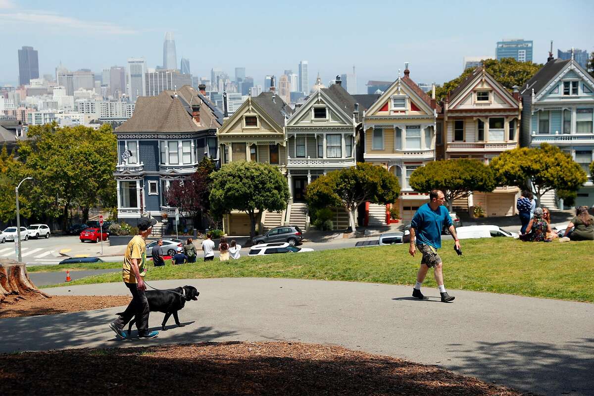 People visit Alamo Square Park near the Painted Ladies in San Francisco, California.