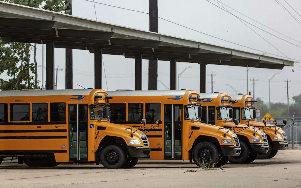 School buses park Wednesday under Big Sun Solar's community solar installation, where students from Poe Middle School were researching how to convert schools to renewable energy.