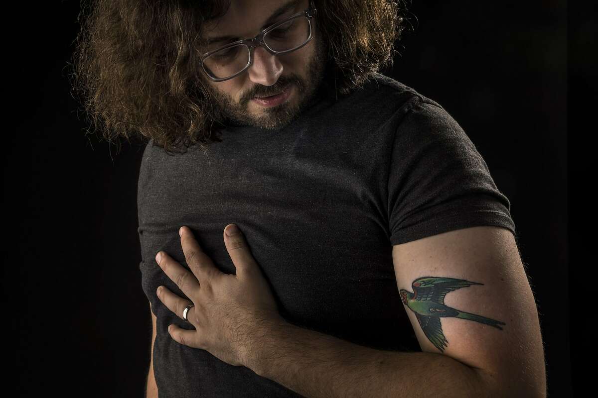 Joe Blubaugh, poses with his tattoo of a parrot which he was inspired to have done by the parrots of Telegraph Hill in San Francisco, Calif., on Thursday, September 16, 2021.