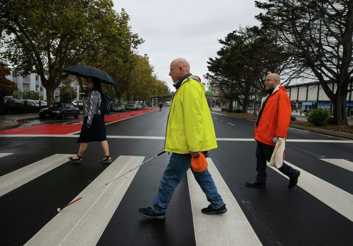 Lou Grosso, 67 (foreground), crosses Geary Street following a press conference celebrating the completion of the Geary Rapid Project at San Francisco’s Japantown Peace Plaza. Grosso is visually impaired and uses the new crosswalk. “I’m glad to be a part of this and that they listened so well,” Grosso said.