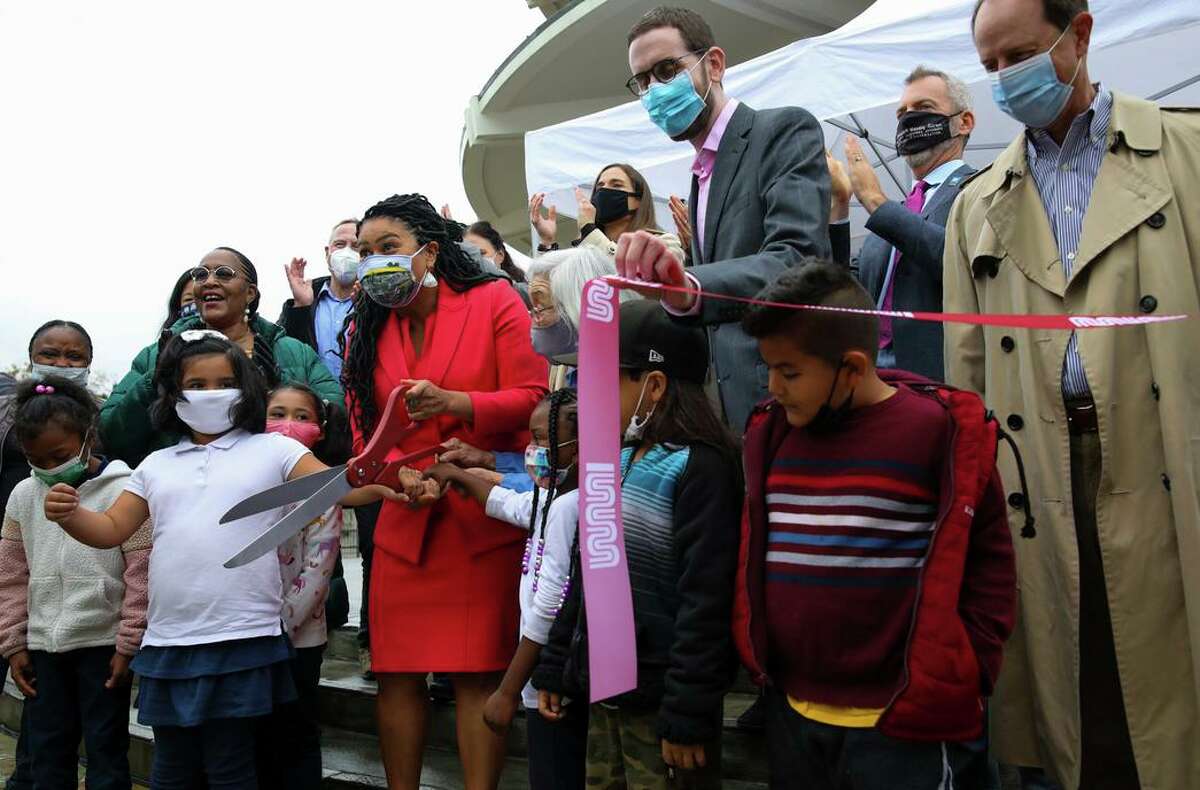 San Francisco Mayor London Breed stands with children from Rosa Parks Elementary School, Sen. Scott Wiener (center, wearing glasses) and community members as they prepare to cut a ribbon celebrating the completion of the Geary Rapid Project at Japantown Peace Plaza.