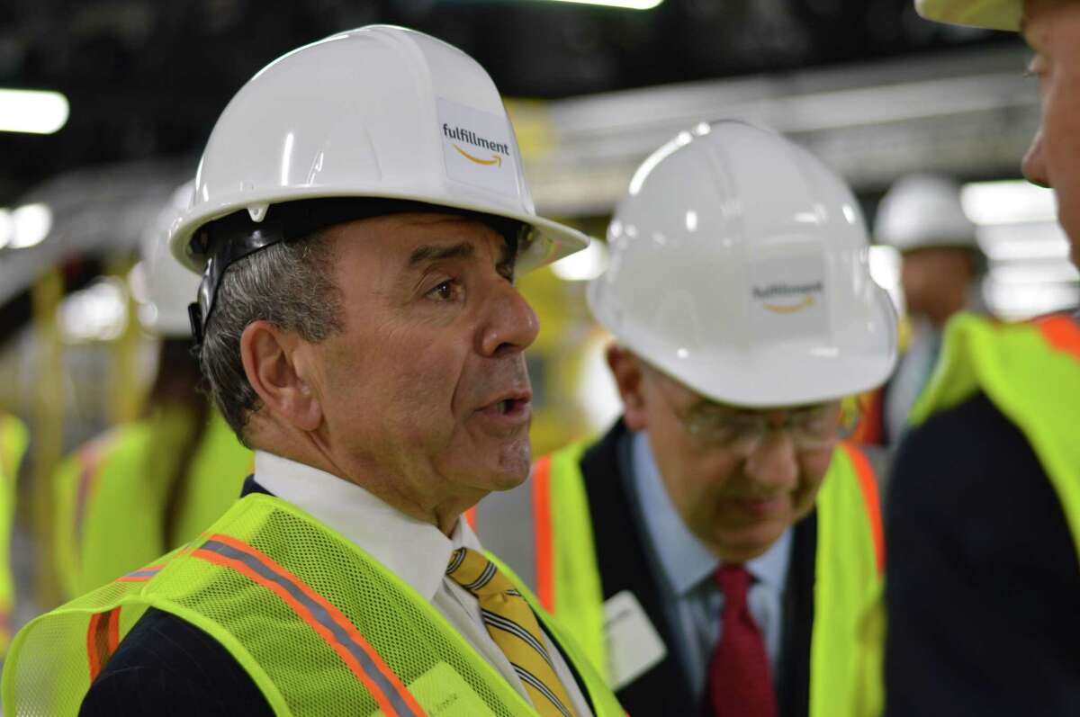North Haven First Selectman Michael Freda, the center, and state and local officials including Governor Ned Lamont, Lieutenant Governor Susan Bysiewicz and Senator Len Fasano, and Martin Looney visited the Amazon distribution center in North Haven for the first time in 2019
