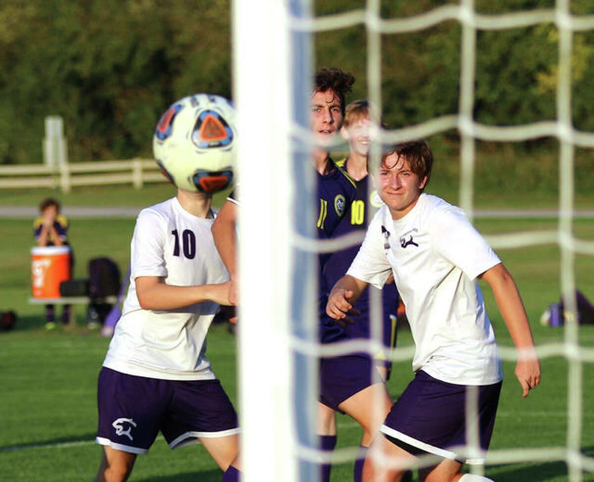 CM’s Parker Scottberg (middle) and two Litchfield defenders watch his shot deflect off the post in the first half of the CM Class 2A Regional on Wednesday at the Bethalto Sports Complex.