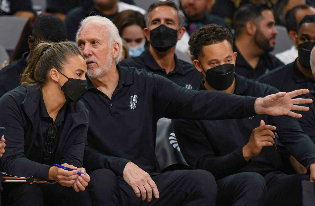 San Antonio Spurs head coach Gregg Popovich speaks with former assistant coach Becky Hammon during NBA action against the Orlando Magic in the AT&T Center on Wednesday, Oct. 20, 2021.