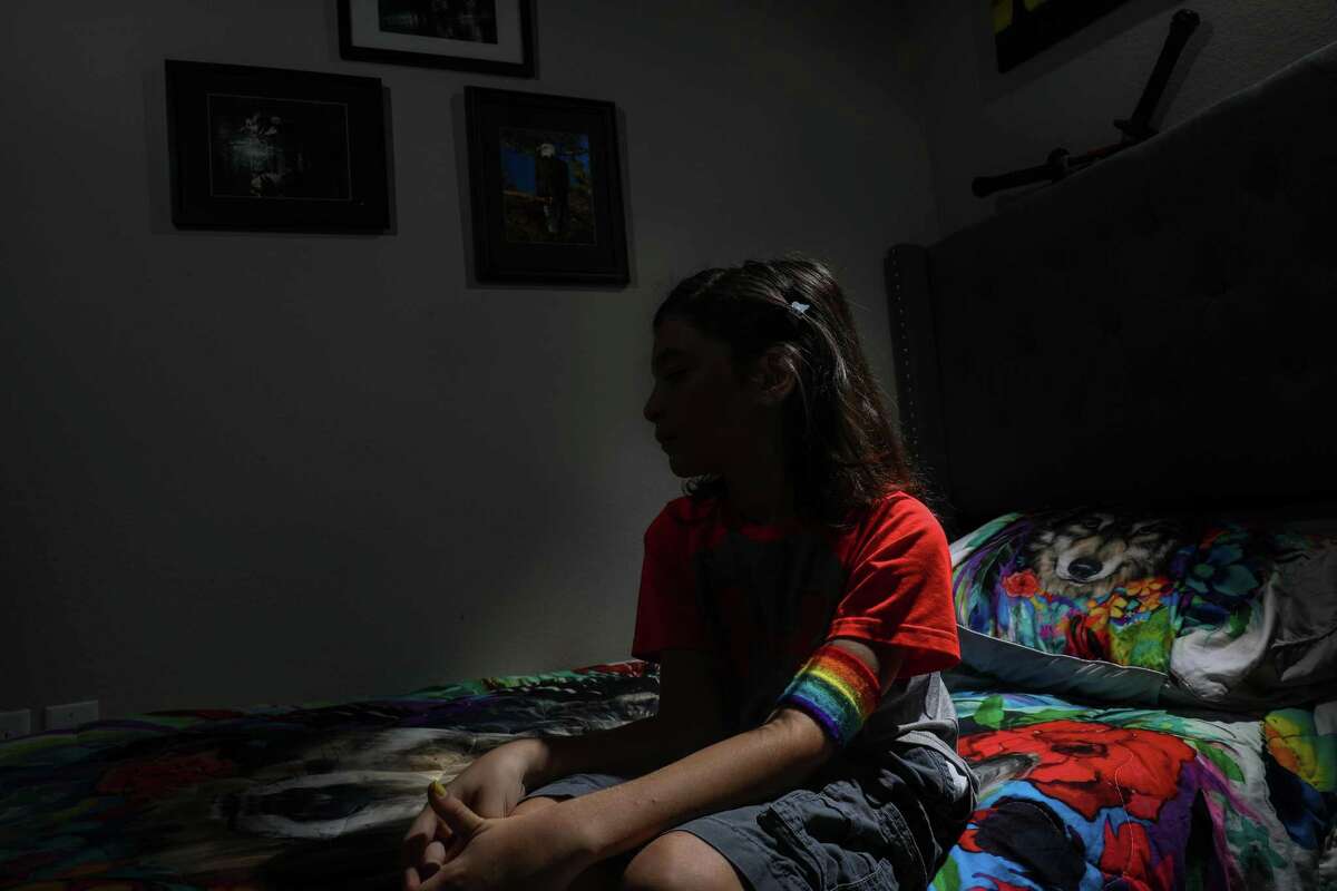 A fifth-grade student in Magnolia ISD poses for a portrait in their bedroom Monday, Aug. 23, 2021, in Magnolia. The child’s mother said the child has been in in-school suspension because of their hair-length. “The school is digging in its heels, and they don’t see how it’s affecting [them] and our family,” the mother said.