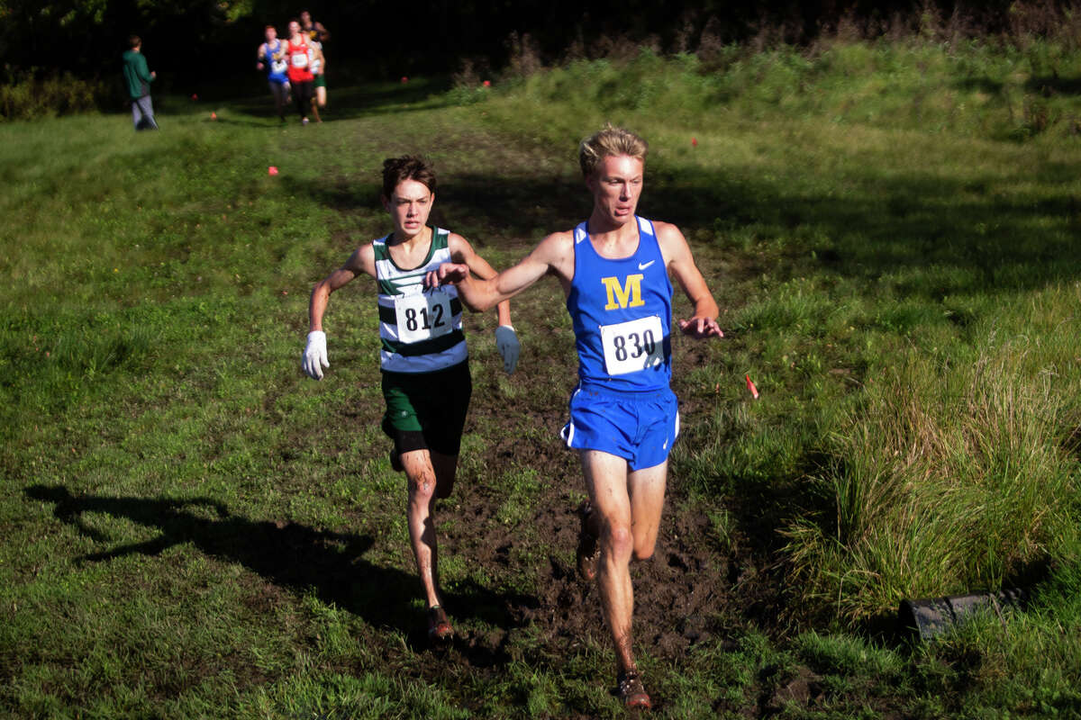 Midland High's Matthew Crowley (front) competes in the Freeland Falcon Invitational on Oct. 16, 2021.