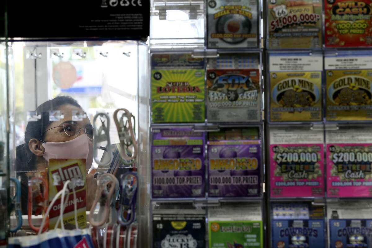 Leticia Morales looks over the inventory as she buys Texas Lottery scratch-off tickets at the Potranco Food Mart on city far northwest side, Thursday, Oct. 1, 2020. The state agency reported $6.704 billion in sales for its 2020 fiscal year Ã?‘ Oct. 1, 2019, to Sept. 30 Ã?‘ a 7.5 percent increase over the previous year. The store is the number one seller of tickets in the city.