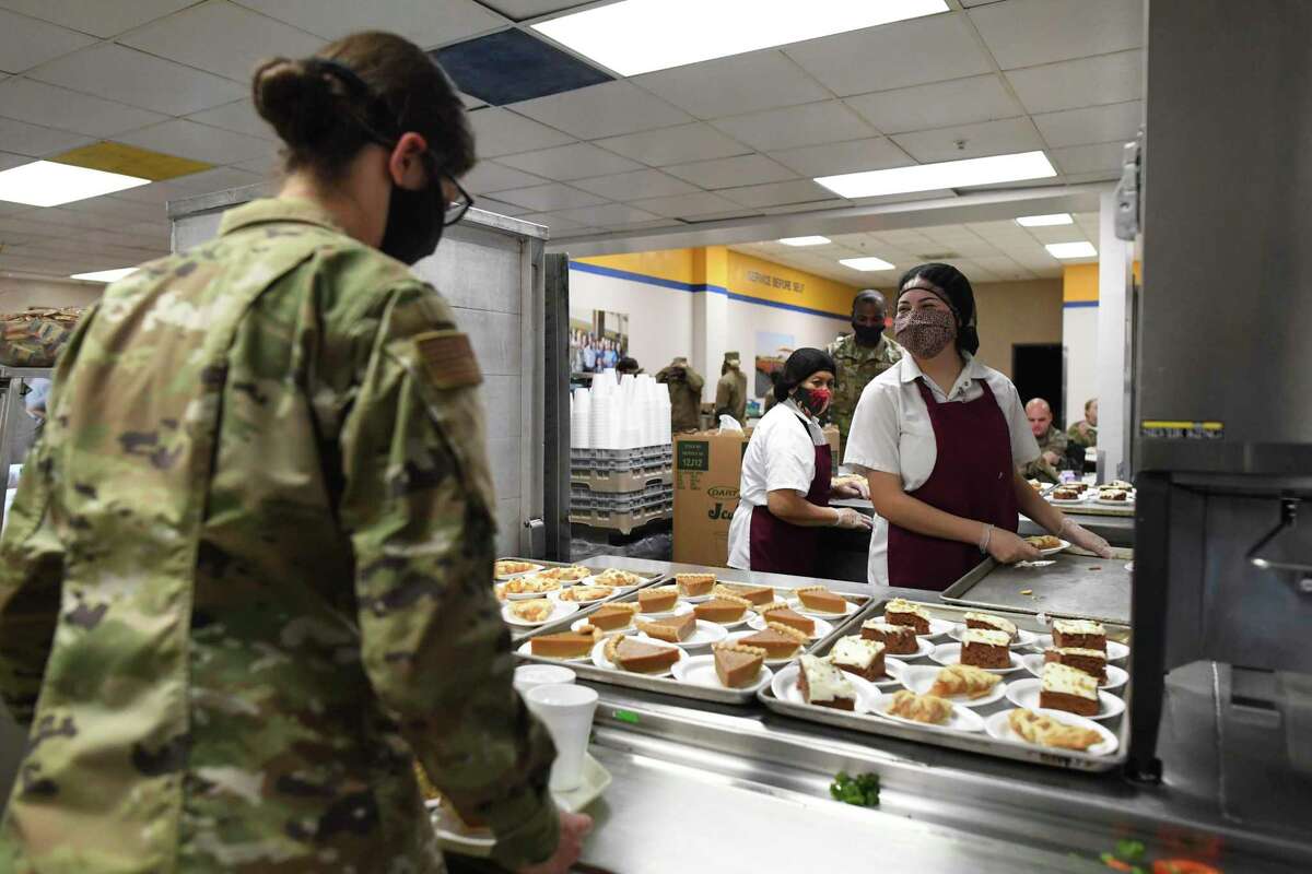 One of the 708 Basic Military Training graduates chooses a pie for her Thanksgiving meal at the Barnes Training Complex at JBSA-Lackland on Thanksgiving Day, 2020. Meals are usually eaten in silence, but on this day, the graduates were encouraged to socialize and celebrate.