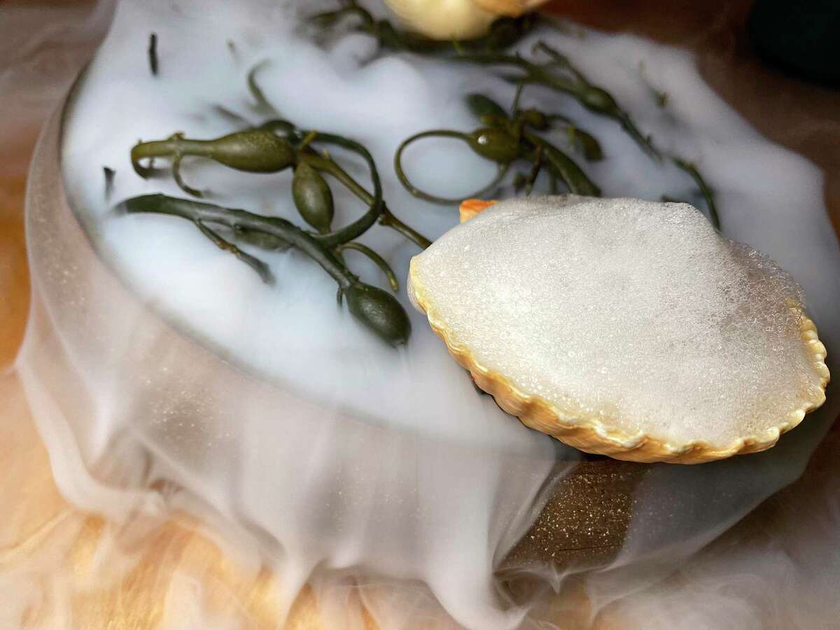 Oaxacan's menu features scallops poached in chili garlic butter with green apple and coconut mousse served over seaweed with dry ice for a dramatic Mixtli twist.