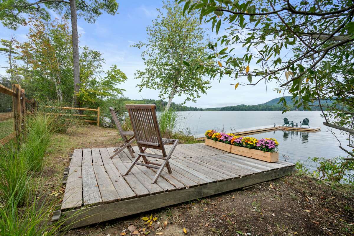 The home on 210 Between The Lakes Road in Salisbury, Conn. has a small deck near Lake Washining. 