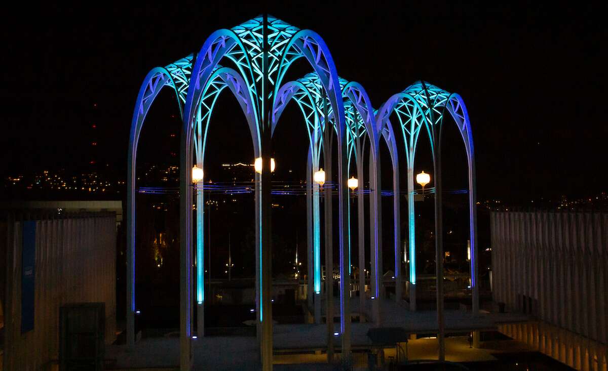 The arches at the Pacific Science Center in Seattle are lit with the colors of the city’s new hockey team.