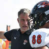 Edwardsville coach Matt Martin talks to Iose Epenesa on the sideline during a game against Belleville East in Belleville.