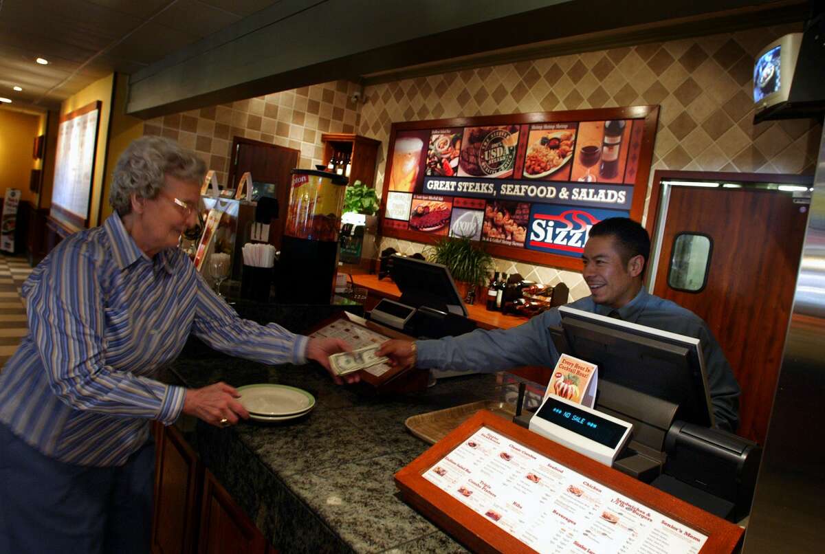It's service with a smile at the front counter at the newly remodeled Sizzler restaurant in Atwater Village, Calif., in 2005.