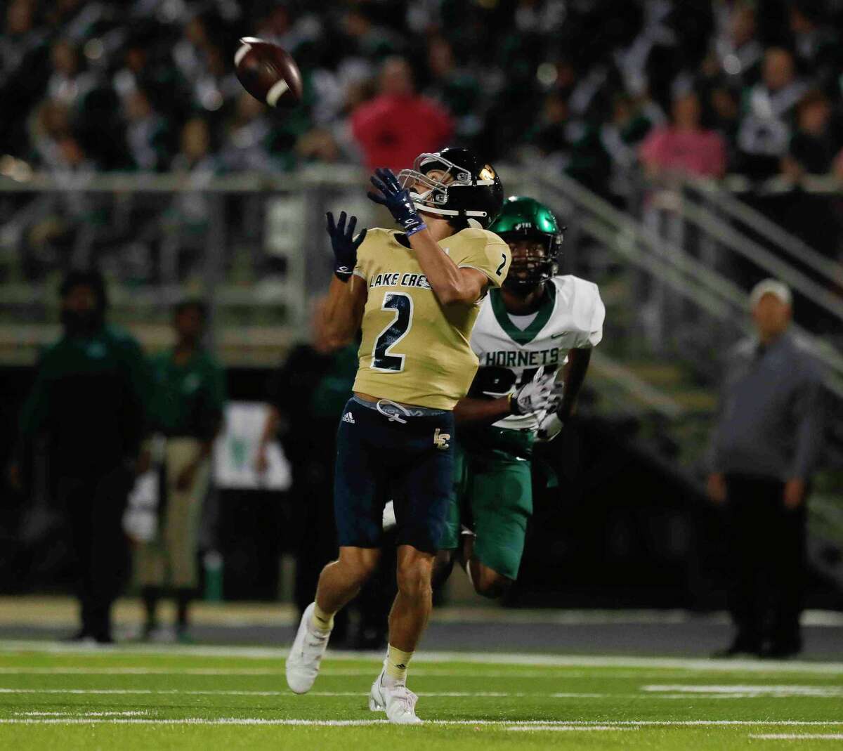 Lake Creek wide receiver Ashlynn Kilgore (2) catches a 75-yard touchdown pass during the first quarter of a District 10-5A (Div. II) high school football game at MISD Stadium, Thursday, Oct. 21, 2021, in Montgomery.