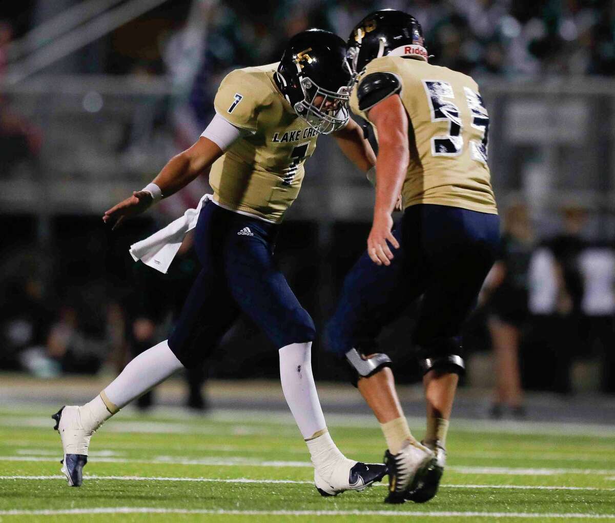 Lake Creek quarterback Cade Tessier (7) reacts after throwing a 34-yard touchdown pass to Madison Hausler during the first quarter of a District 10-5A (Div. II) high school football game at MISD Stadium, Thursday, Oct. 21, 2021, in Montgomery.