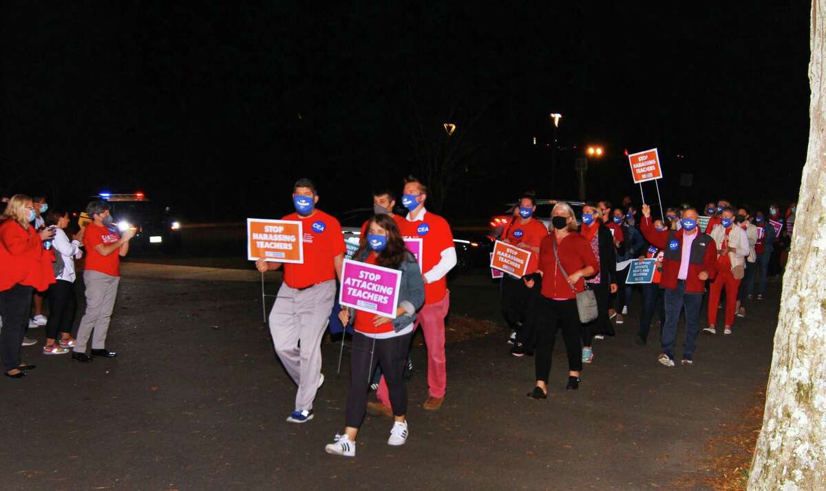 Educators, parents and students hold a march and rally to end attacks against teachers ahead of the Board of Education meeting at Central Middle School in Greenwich, Conn., on Thursday October 21, 2021. They are calling for an end to the increased attacks on teachers and the curriculum in the Greenwich Public Schools in recent months.
