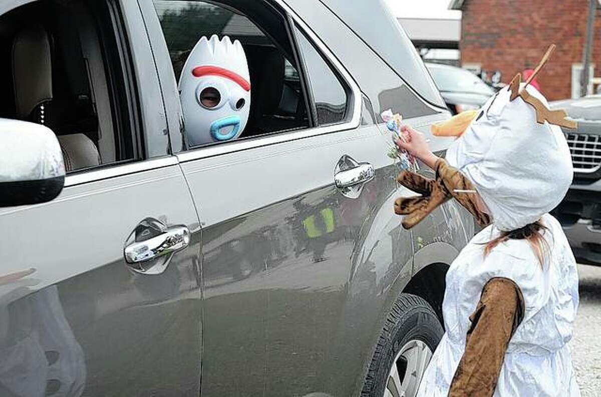 A child dressed as Forky from “Toy Story 4” gets candy Thursday during Safe Halloween.