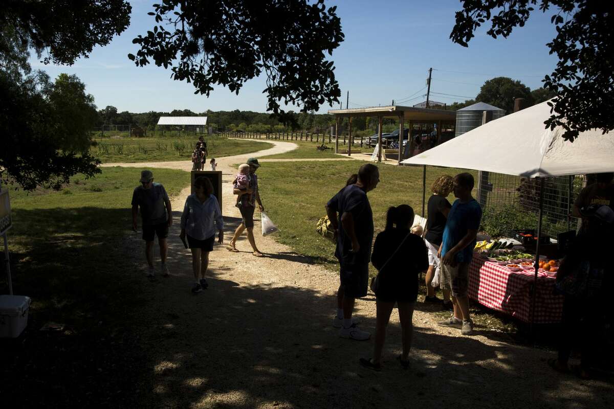 People enter a farmers market at Herff Farm in Boerne in 2017.