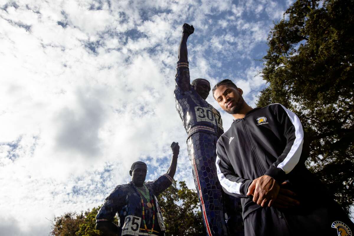 San Jose State University basketball player Richard Washington poses for a photograph next to the Olympic Black Power Statue on the SJSU campus in San Jose, Calif., on Oct. 21, 2021.