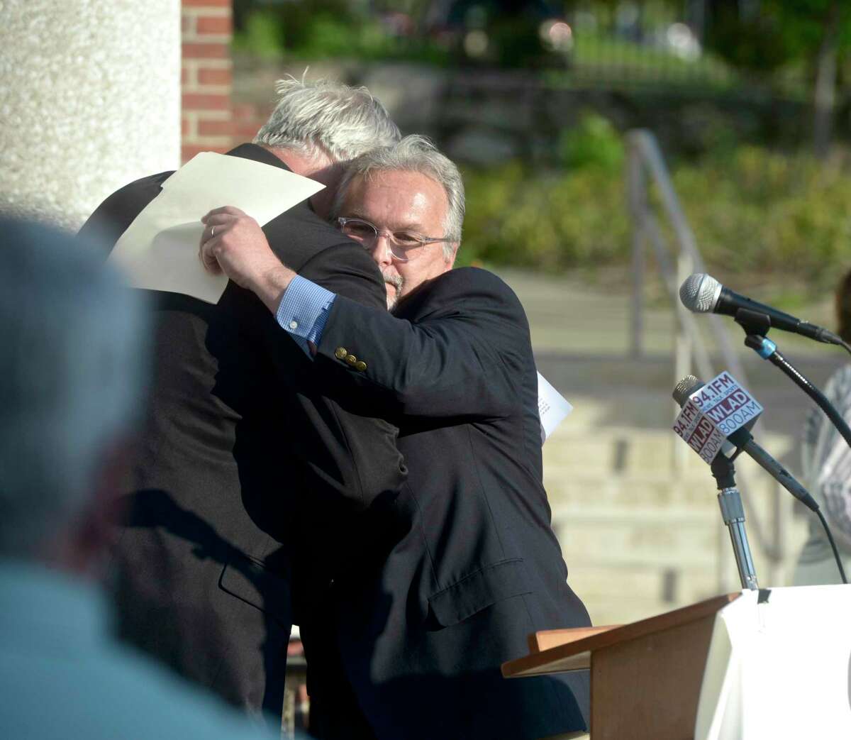After announcing he would not be running for mayor in the next election, Mayor Joseph Cavo gets a hug from Dean Esposito who he endorsed for the office of mayor. At City Hall on Tuesday evening. May 18, 2021, in Danbury, Conn. Esposito will be sworn in on Tuesday evening. His term officially begins at noon on Wednesday.
