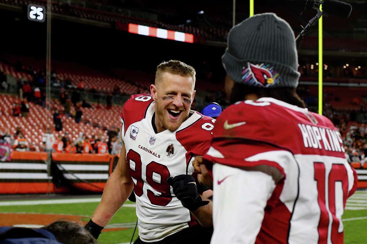 Arizona Cardinals defensive end J.J. Watt (99) congratulates wide receiver DeAndre Hopkins (10) after an NFL football game against the Cleveland Browns, Sunday, Oct. 17, 2021, in Cleveland. (AP Photo/Kirk Irwin)