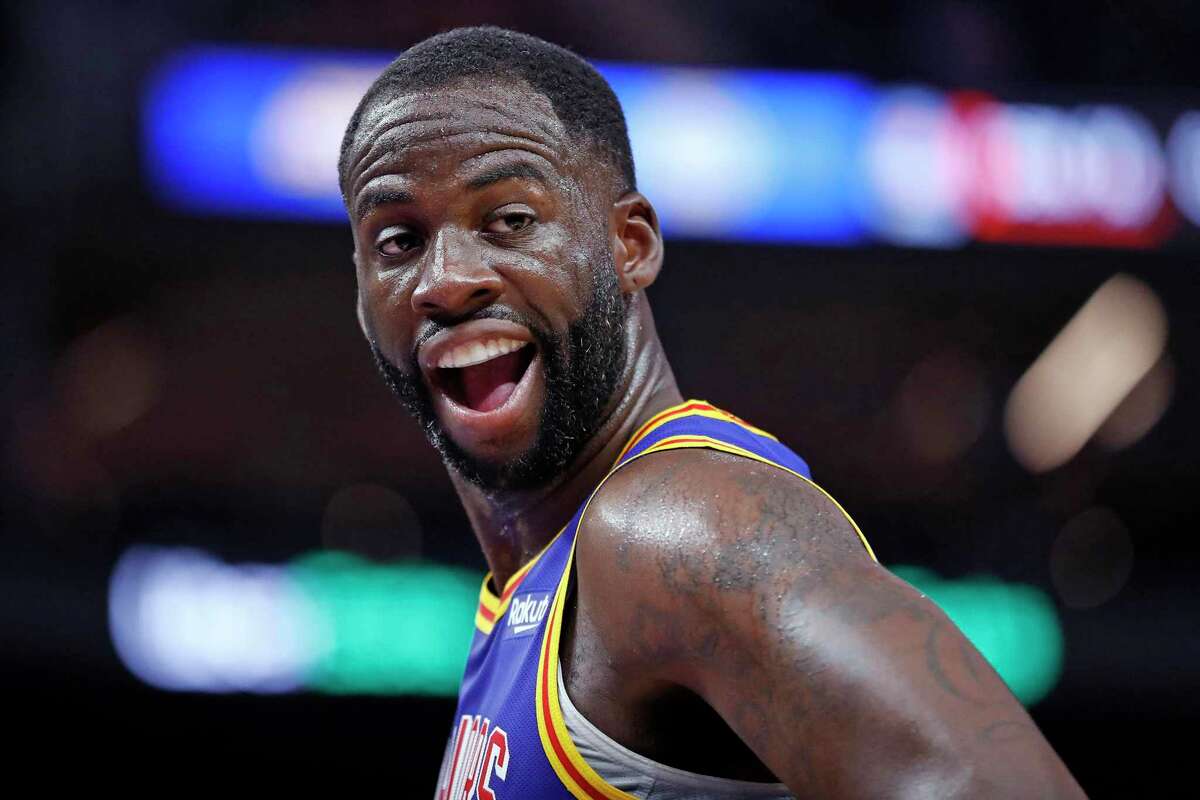 Golden State Warriors' Draymond Green reacts to seeing his wife and children courtside during 2nd quarter against Los Angeles Clippers during NBA game at Chase Center in San Francisco, Calif., on Thursday, October 21, 2021.