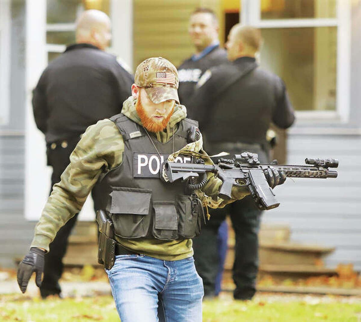 John Badman|The Telegraph Alton Police officers conducted a drug related search warrant Friday morning in the 2700 block of Walnut Street in Alton. Some of the officers were heavily armed with assault weapons and broke down the front door with a battering ram.