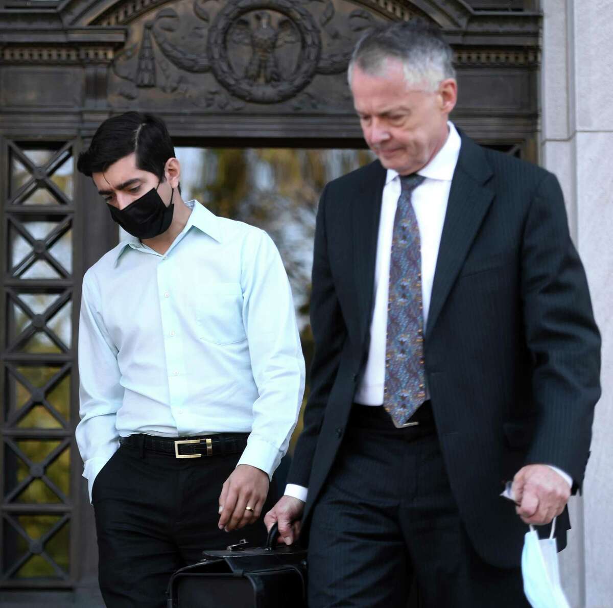 Former Connecticut state Rep. Michael DiMassa (left) leaves the federal courthouse in New Haven with his attorney, John Gulash, following his arrest on one count of wire fraud on Oct. 20, 2021.