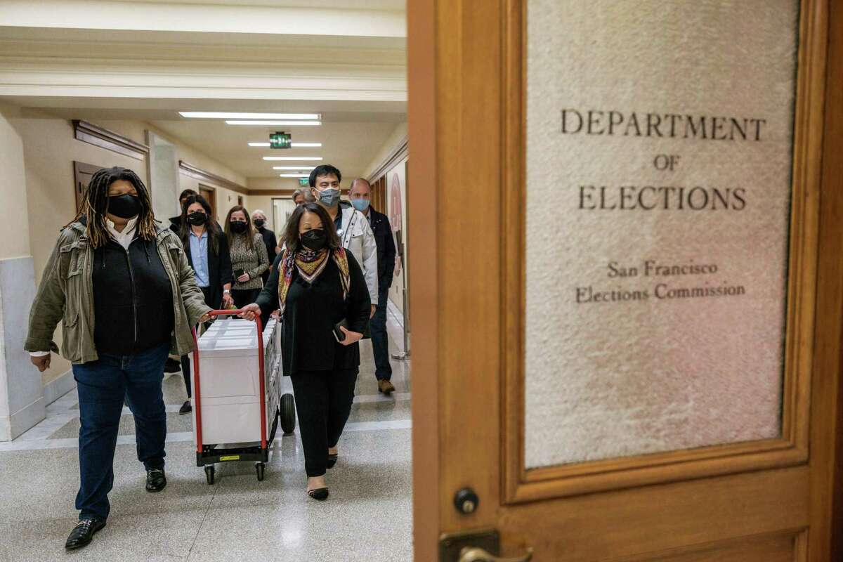 Organizers with the recall campaign against San Francisco District Attorney Chesa Boudin walk tens of thousands more signatures than required to qualify for the ballot to the Department of Elections office at City Hall.
