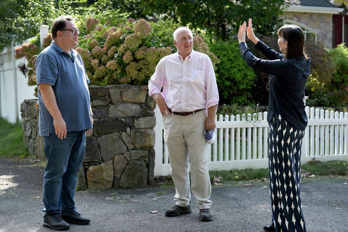 William Kelly, center, the Democratic candidate for first selectman in Greenwich, chats with Joe Gross, left, and Gerri Flemming, right, during a campaign walk Saturday, Oct. 16, 2021.