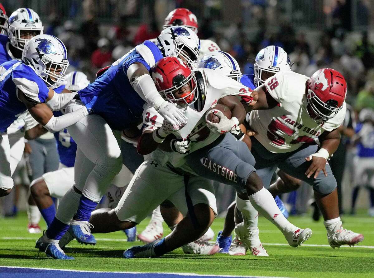 North Shore running back Rashaad Johnson (34) is tackled near the goal line by C.E. King defensive lineman JJ Auzenne during the first half of a high school football game, Friday, Oct. 22, 2021, in Houston.