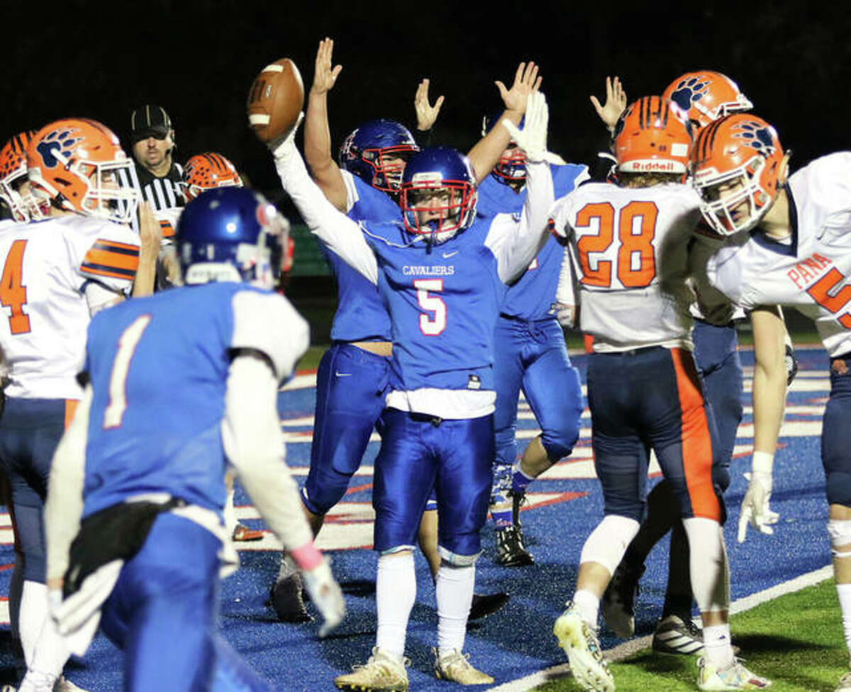 Carlinville RB Mason Patton (5) signals touchdown in front of two Cavaliers linemen before celebrating with WR Ethen Siglock (1) after scoring a go-ahead TD in the fourth quarter Friday night at Carlinville. Pana answered with two TDs to win 27-13 and complete a 9-0 regular-season and SCC championship.