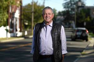 Hector Arzeno, of Cos Cob, poses along Delavan Avenue in the Byram section of Greenwich, Conn. Thursday, Oct. 21, 2021. Since 2010, Greenwich’s population has risen 3.8 percent and Hispanic-identifying residents made up 93 percent of that increase. The majority of those new residents have settled on the west side of town in Byram and Chickahominy.
