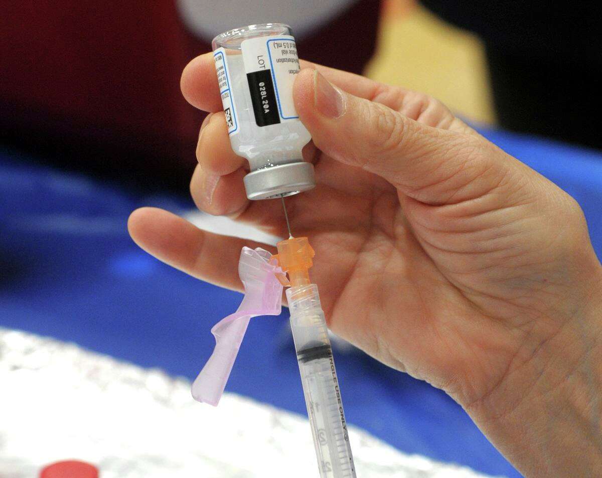 A nurse fills a syringe with a shot of COVID-19 vaccine at the vaccination clinic set up in the gymnasium of the Bigelow Center for Senior Activities, in Fairfield, Conn. Jan. 27, 2021.
