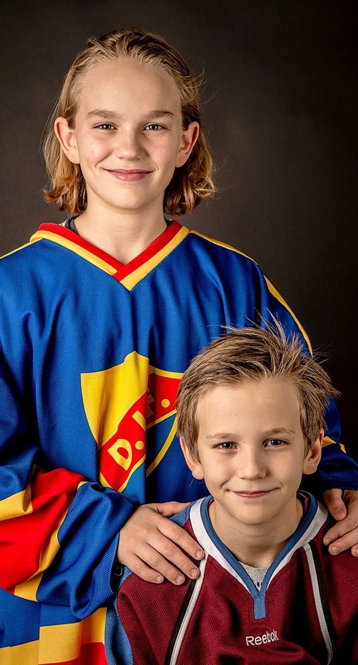 William Eklund (age 12) poses with his younger brother, Victor (age 8).