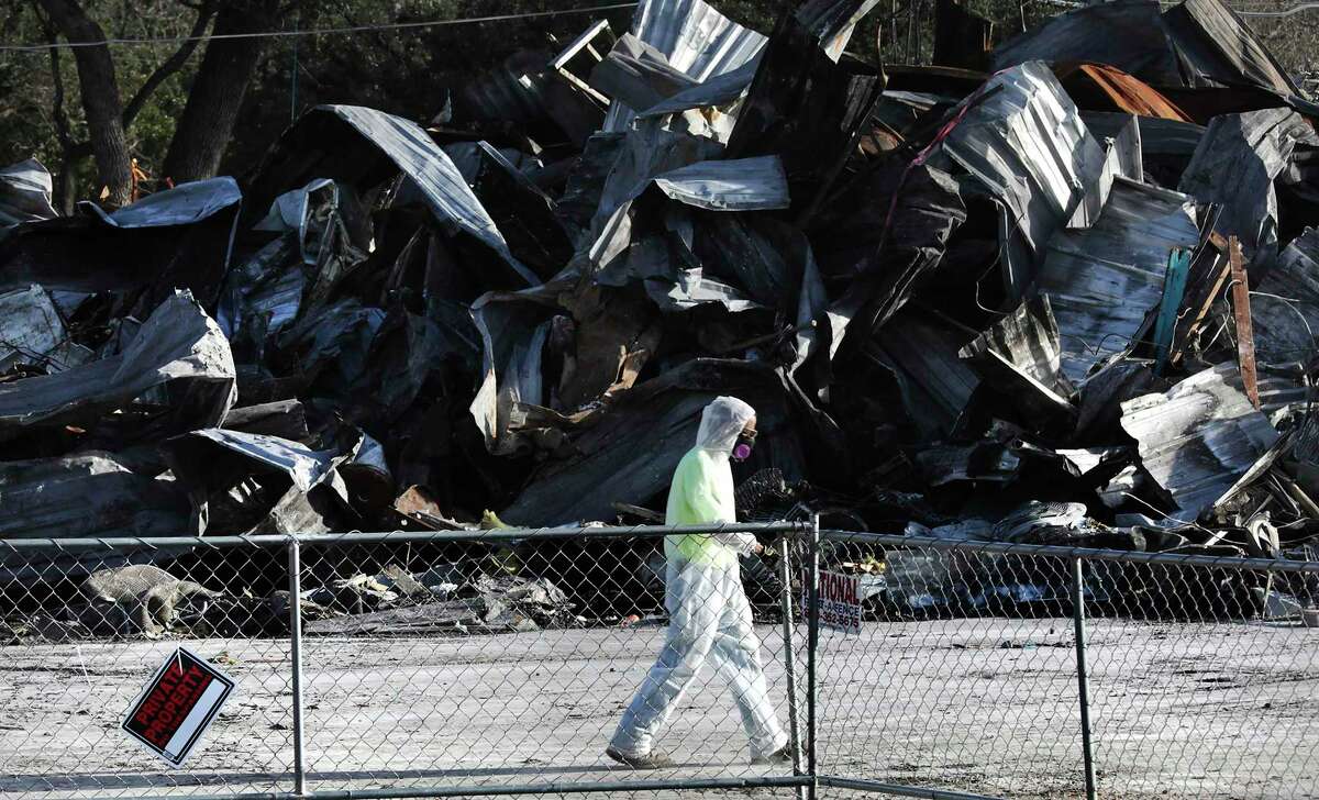 A construction worker protected from asbestos works at the scene of the deadly fire at Iconic Village Apartments in San Marcos in January 2019, nearly six months after the catastrophe. The victims' building ravaged by fire was later demolished.