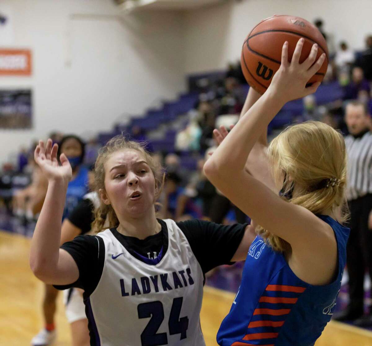 Willis guard Kylie Santore (24) attempts to block Grand Oaks small forward Kylee Myers (12) from passing the ball during the third quarter of a District 13-6A girls basketball game at Willis High School, Saturday, Jan. 2, 2020, in Willis.